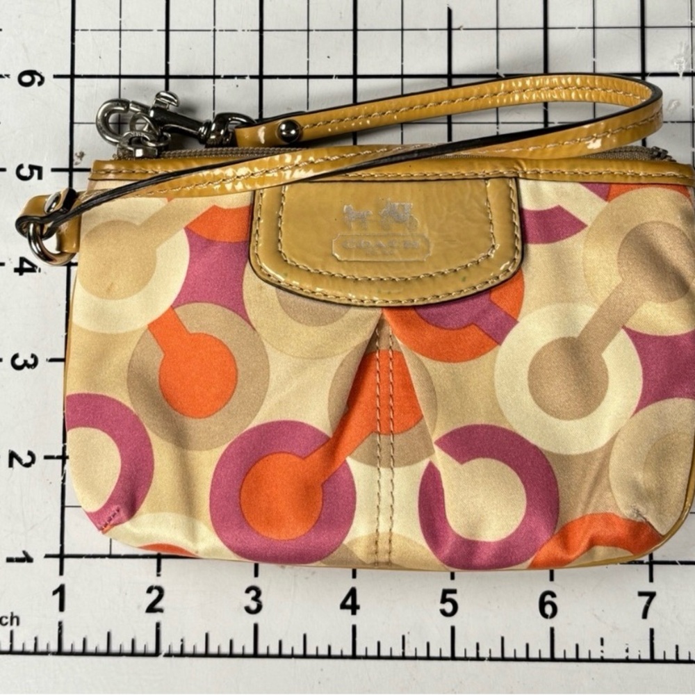 Coach Optic C Colorful Patterned Wristlet
Orange pink cream. Patent Leather - Picture 10 of 11